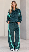 Full front view of women's dark green velour tracksuit set with mint side stripes