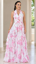 Front view of woman wearing white floral halter neck tiered maxi dress