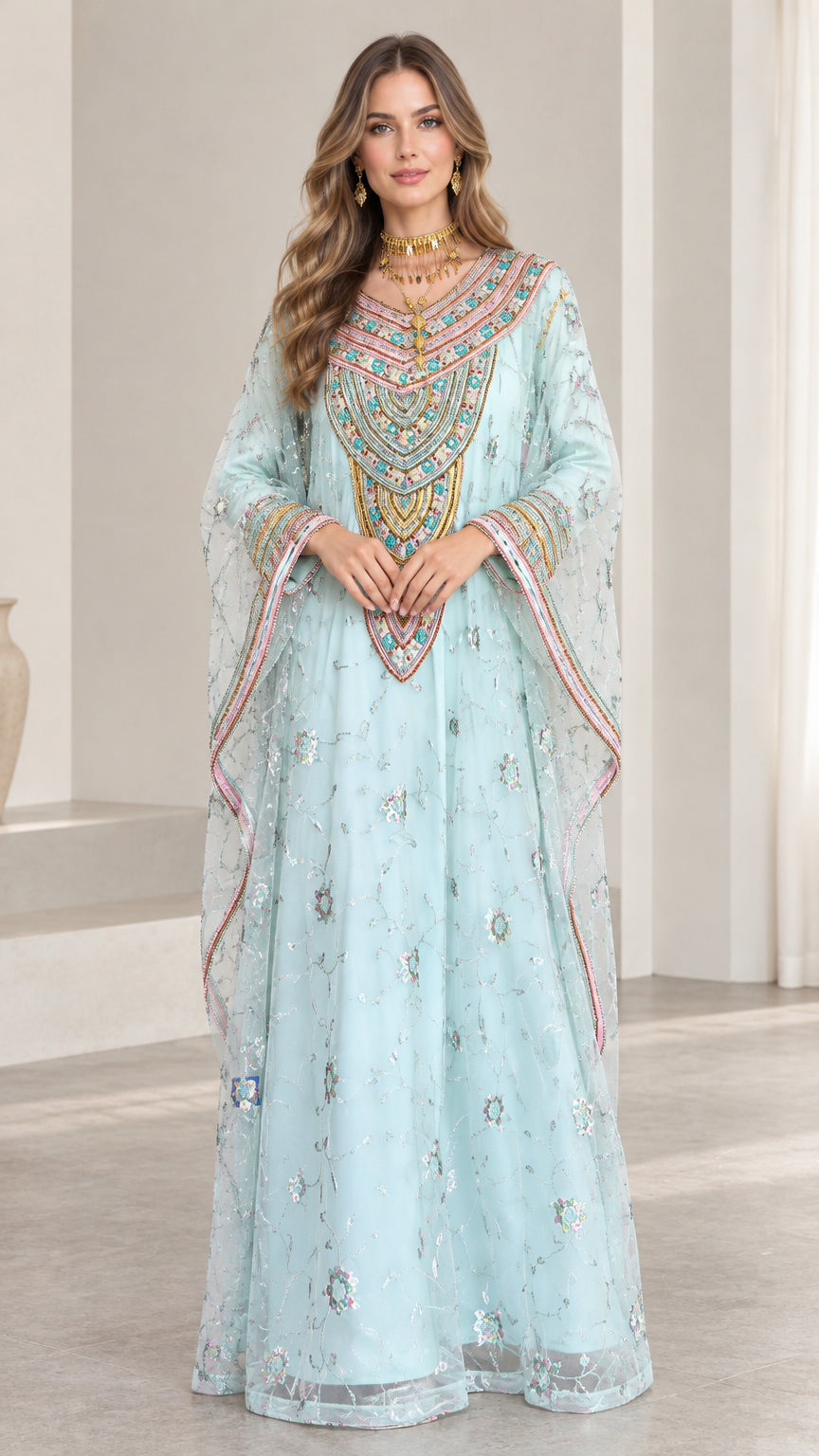 Front full-length view of woman wearing sky blue embroidered kaftan dress with sequin details