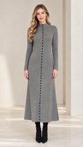 Front view of model wearing a Heather Grey mock neck button front maxi knit dress with black heeled boots