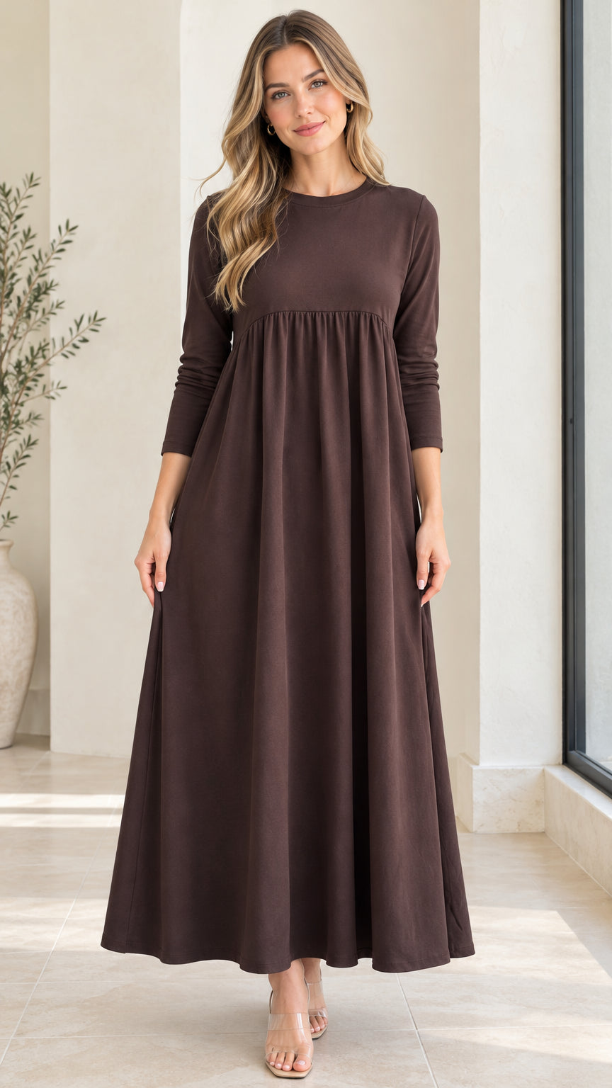 Front full-length view of model wearing chocolate brown long sleeve empire waist maxi dress
