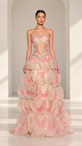 Front full view of Blush Pink strapless beaded corset evening gown with petal tiered skirt