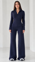 Full front view of women's navy blue quarter-zip top and wide-leg flare pants set