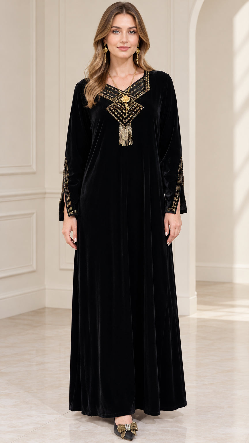 Front full-length view of woman wearing black embroidered velvet maxi dress