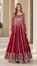 Front view of woman wearing burgundy embroidered long sleeve flared maxi gown