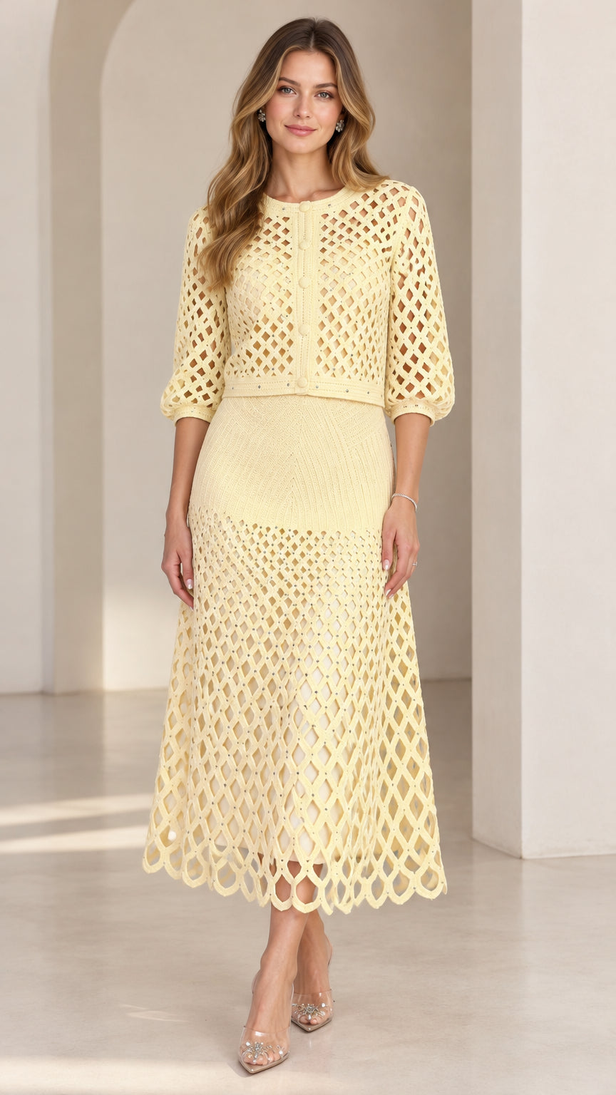 Pale yellow openwork crochet cardigan and midi skirt two-piece set on model