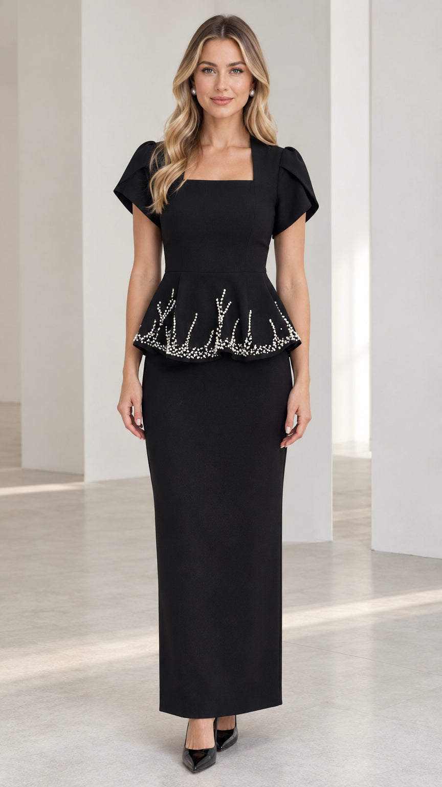 Front view of model wearing black square neck beaded peplum maxi dress
