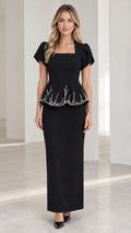Front view of model wearing black square neck beaded peplum maxi dress