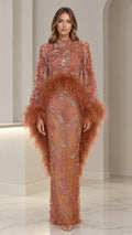 Front view of woman wearing terracotta high-neck sequin evening gown with feather trim