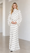 Front view of model wearing white high neck polka dot long sleeve maxi dress