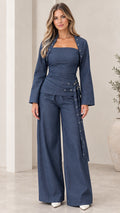 Model wearing Navy Blue 3-piece wide leg pant set with cropped jacket and bandeau top - front view