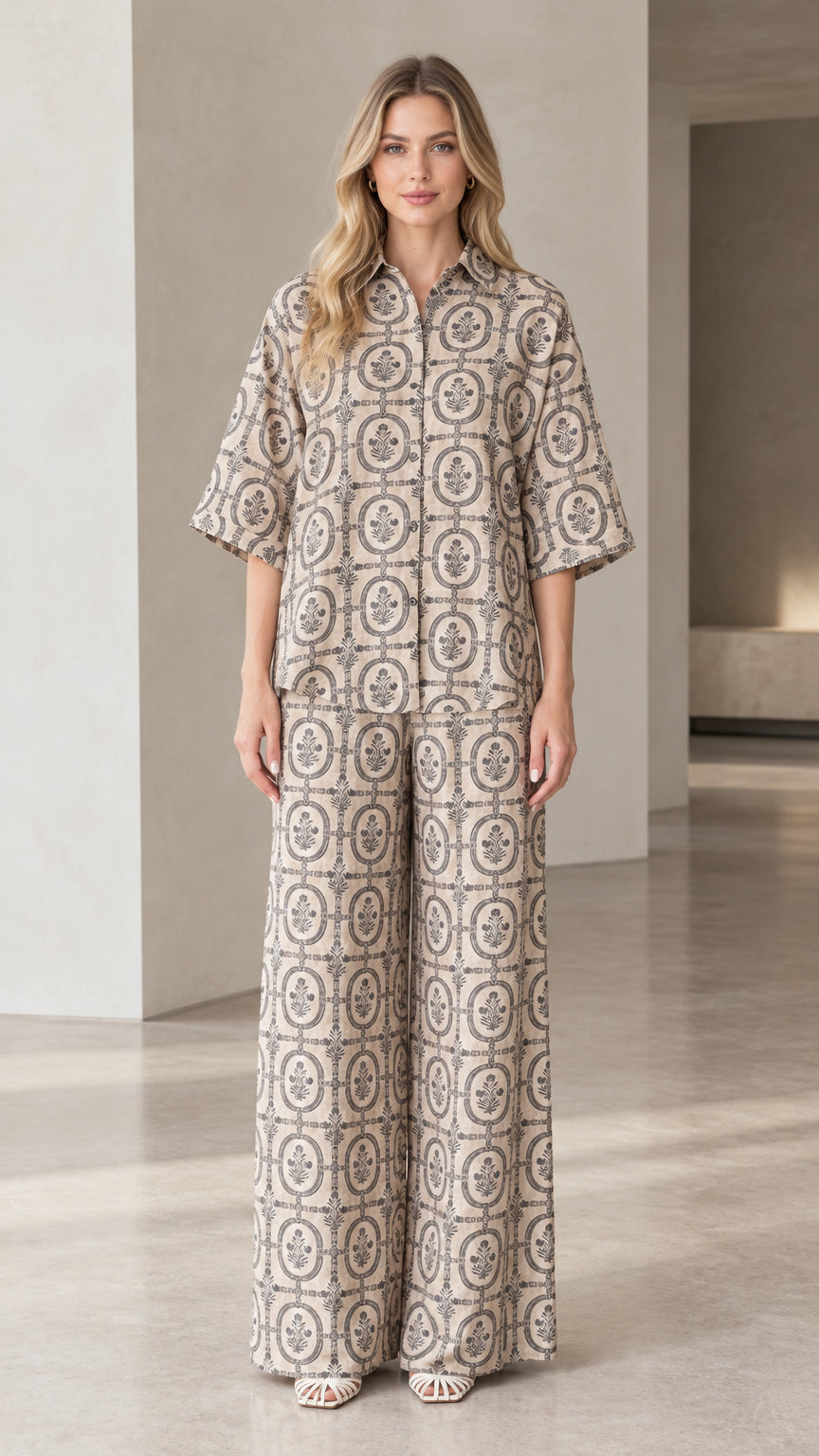 Front full view of woman wearing beige vintage medallion print button-down shirt and matching wide-leg pants