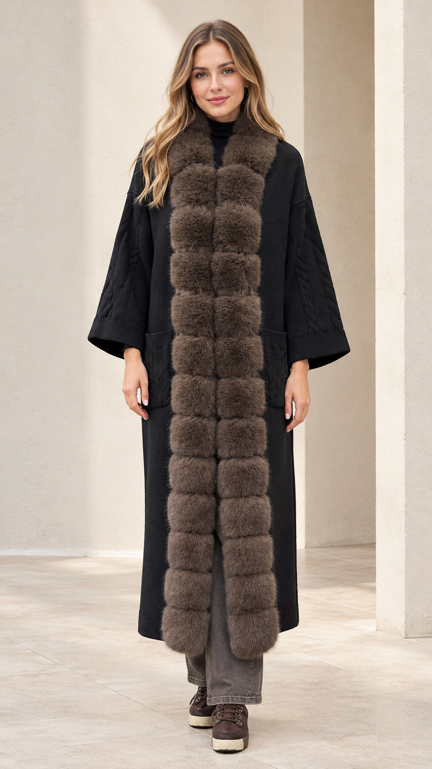 Front view of model wearing black maxi knit cardigan coat with faux fur trim
