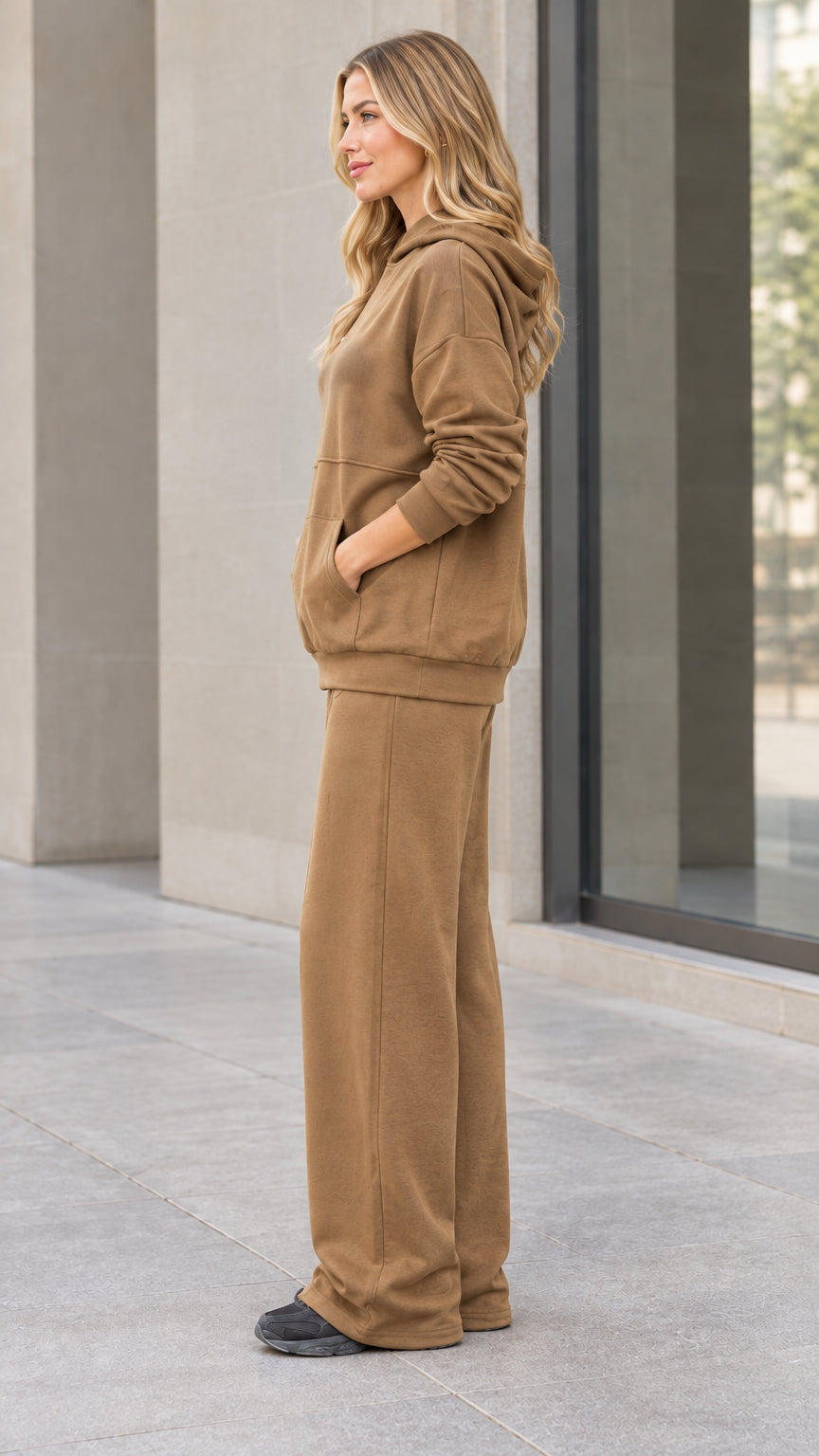 Side profile of woman wearing camel hoodie and wide-leg sweatpants set
