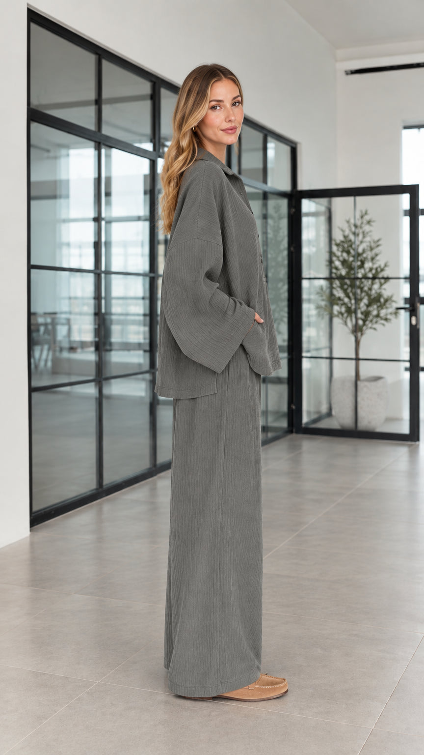 Side profile of women's charcoal grey oversized matching pants set