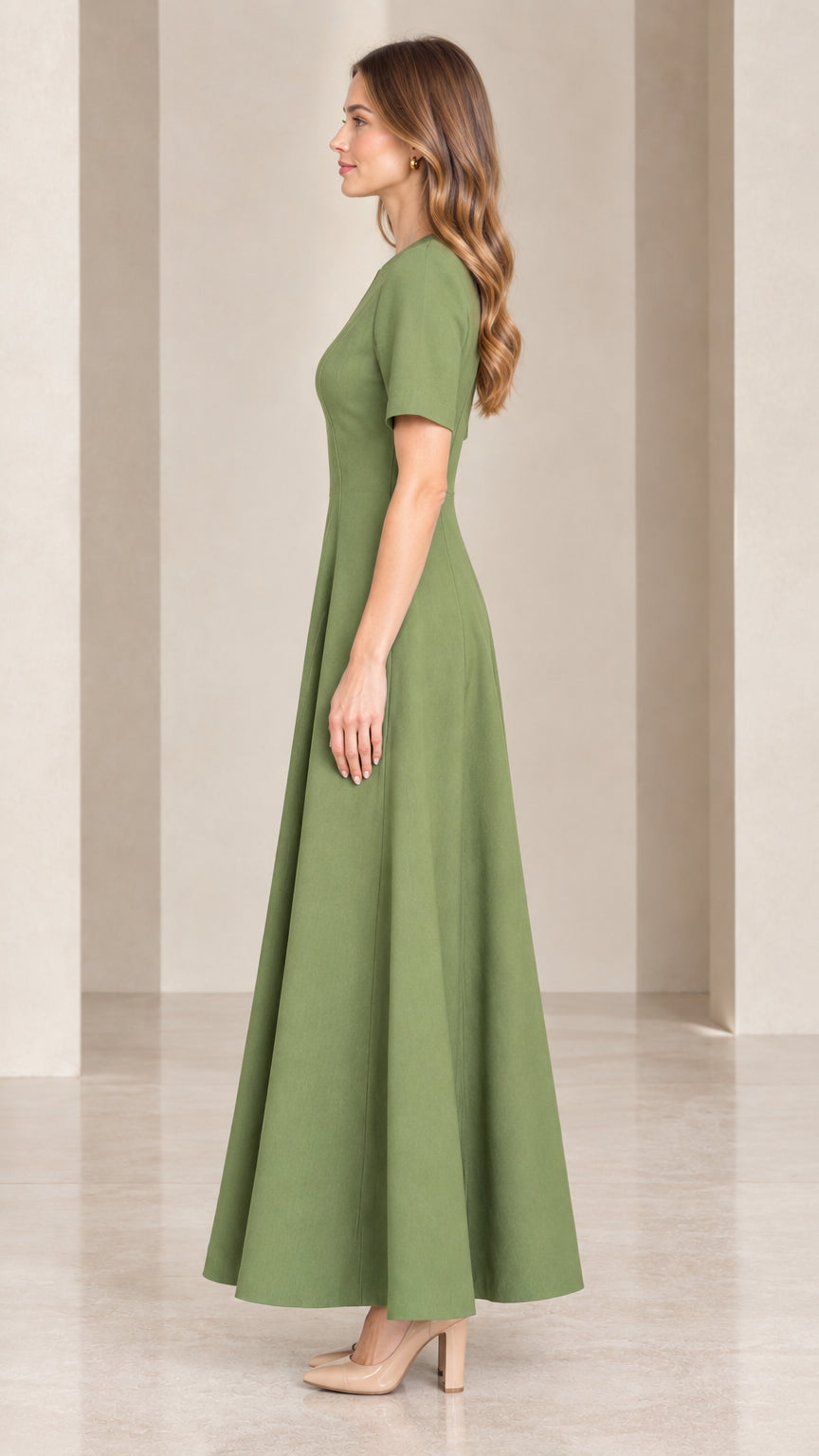 Side profile view of woman wearing sage green tailored maxi dress