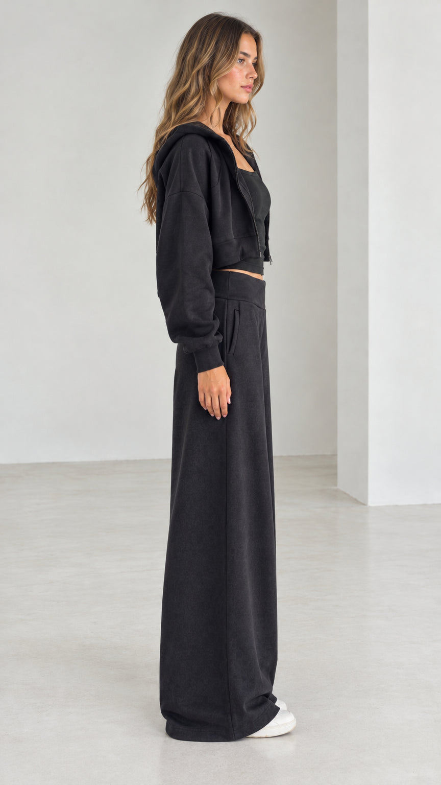 Side profile view of model wearing the black 3-piece matching loungewear set