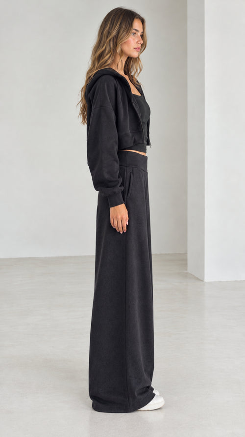 Side profile view of model wearing the black 3-piece matching loungewear set