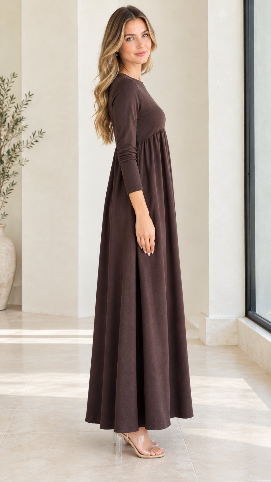 Side profile view of model wearing chocolate brown flowy long sleeve maxi dress