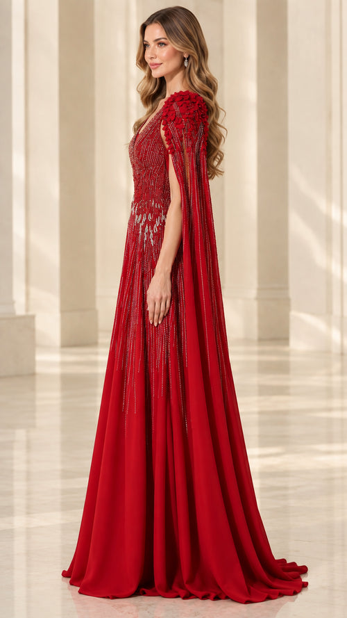 Side profile of red formal cape sleeve gown showing elegant drape and silhouette