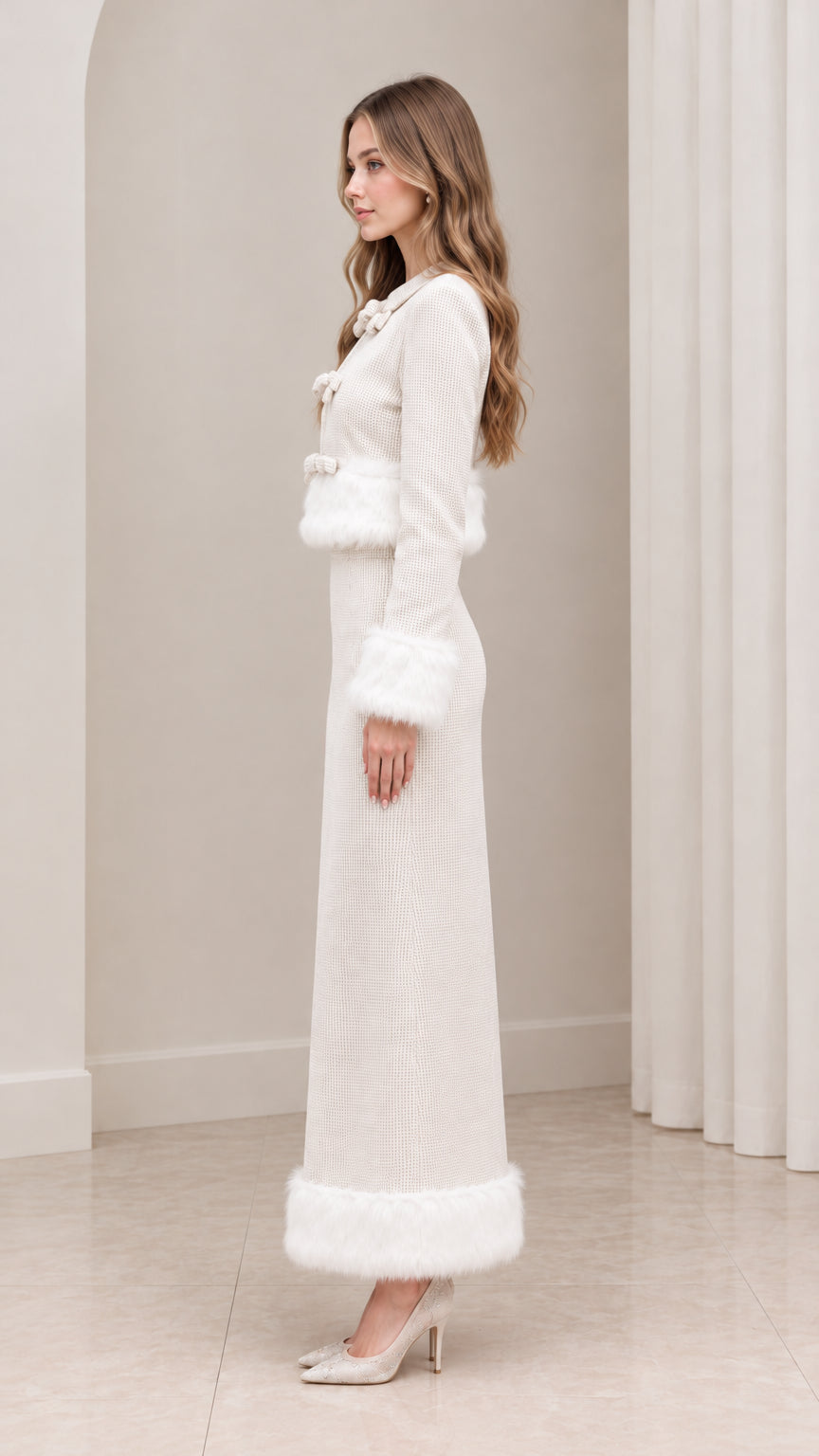Side profile of woman wearing ivory bow front cropped jacket and maxi skirt set