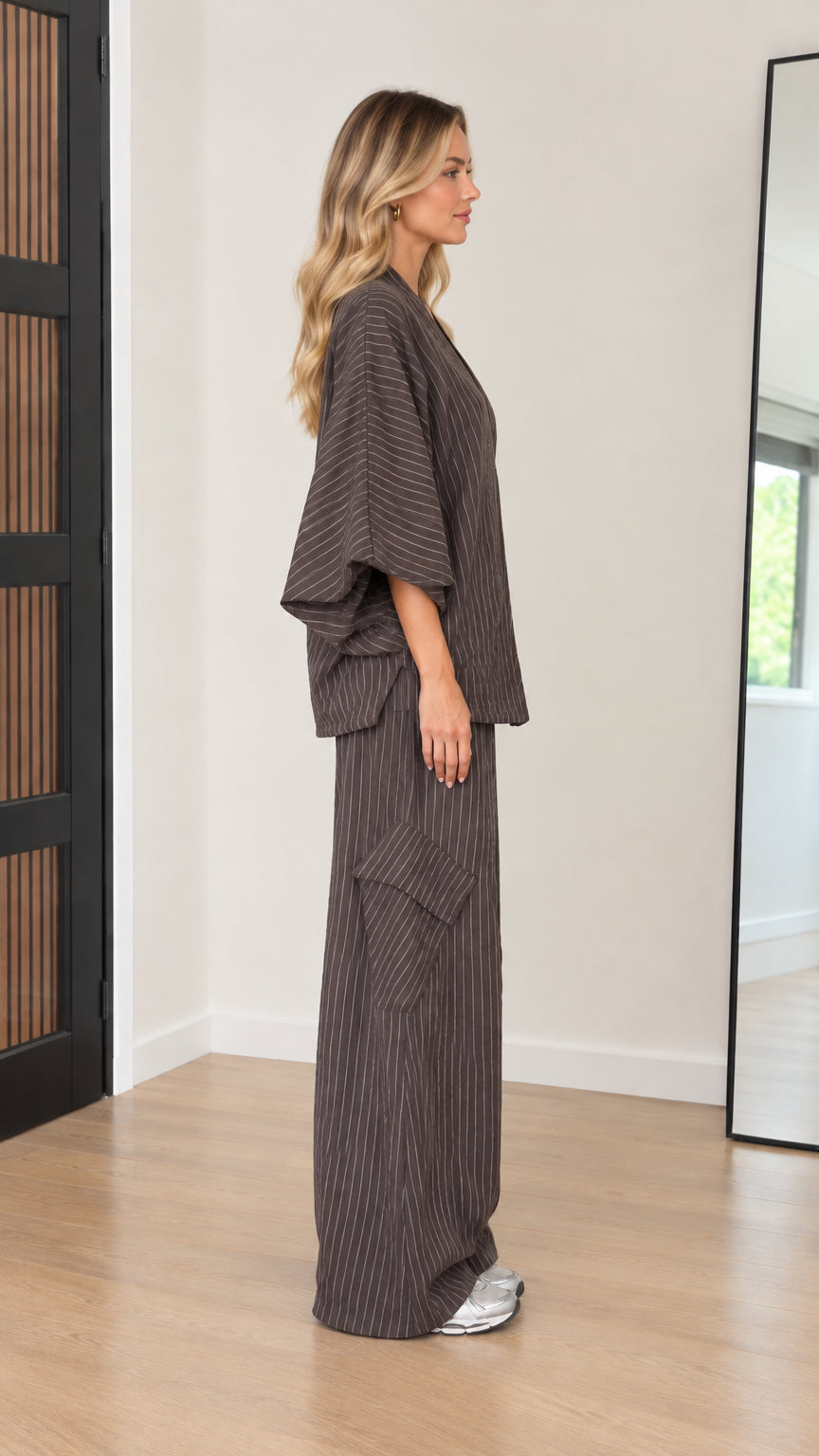 Side profile of women's relaxed pinstripe matching lounge set in mocha brown