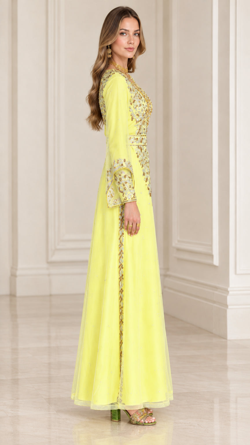 Side profile view of woman wearing yellow gold-embroidered evening gown