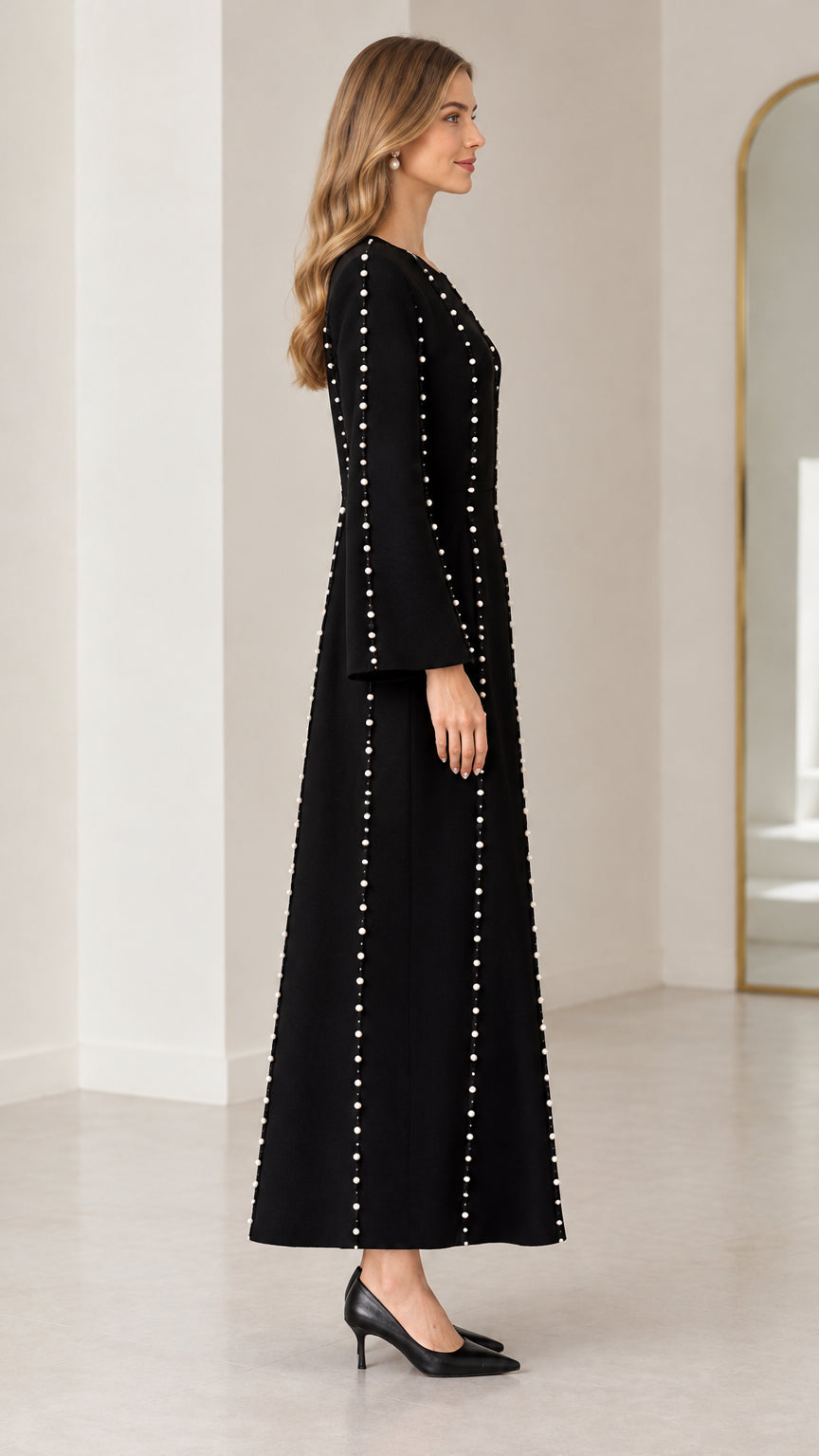 Side view of black A-line maxi dress with beaded details