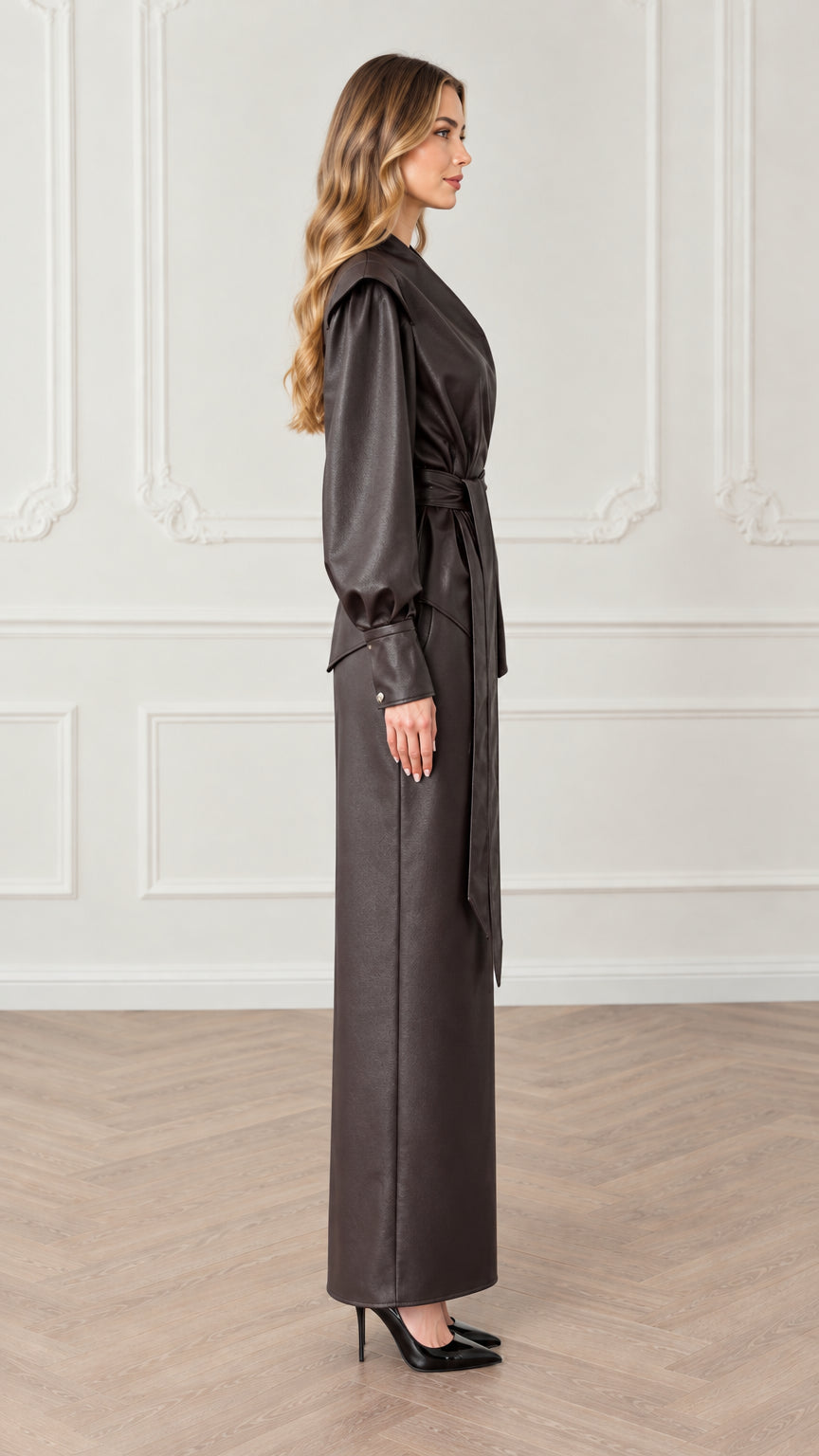 Side profile view of dark brown faux leather wrap top and column maxi skirt set