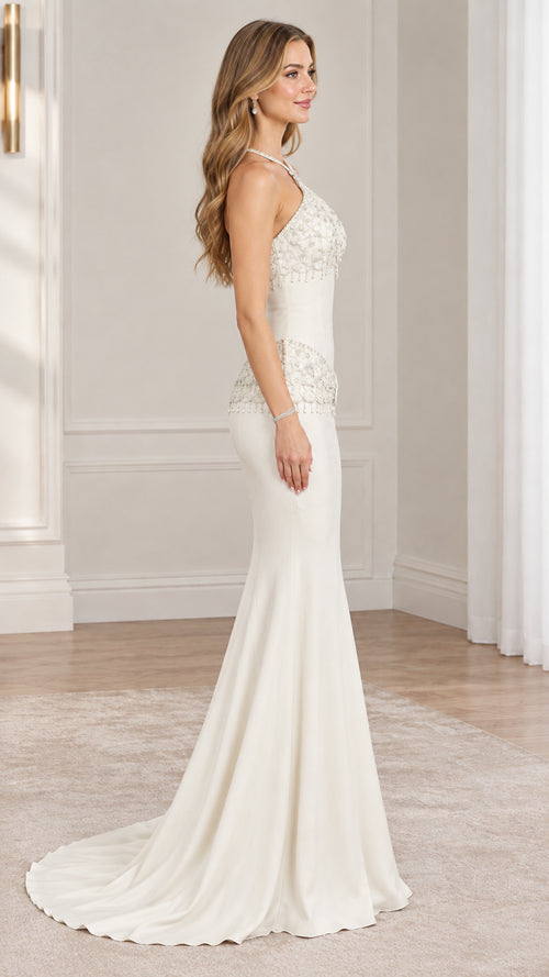 Side profile view of ivory beaded halter formal dress showing silhouette and train