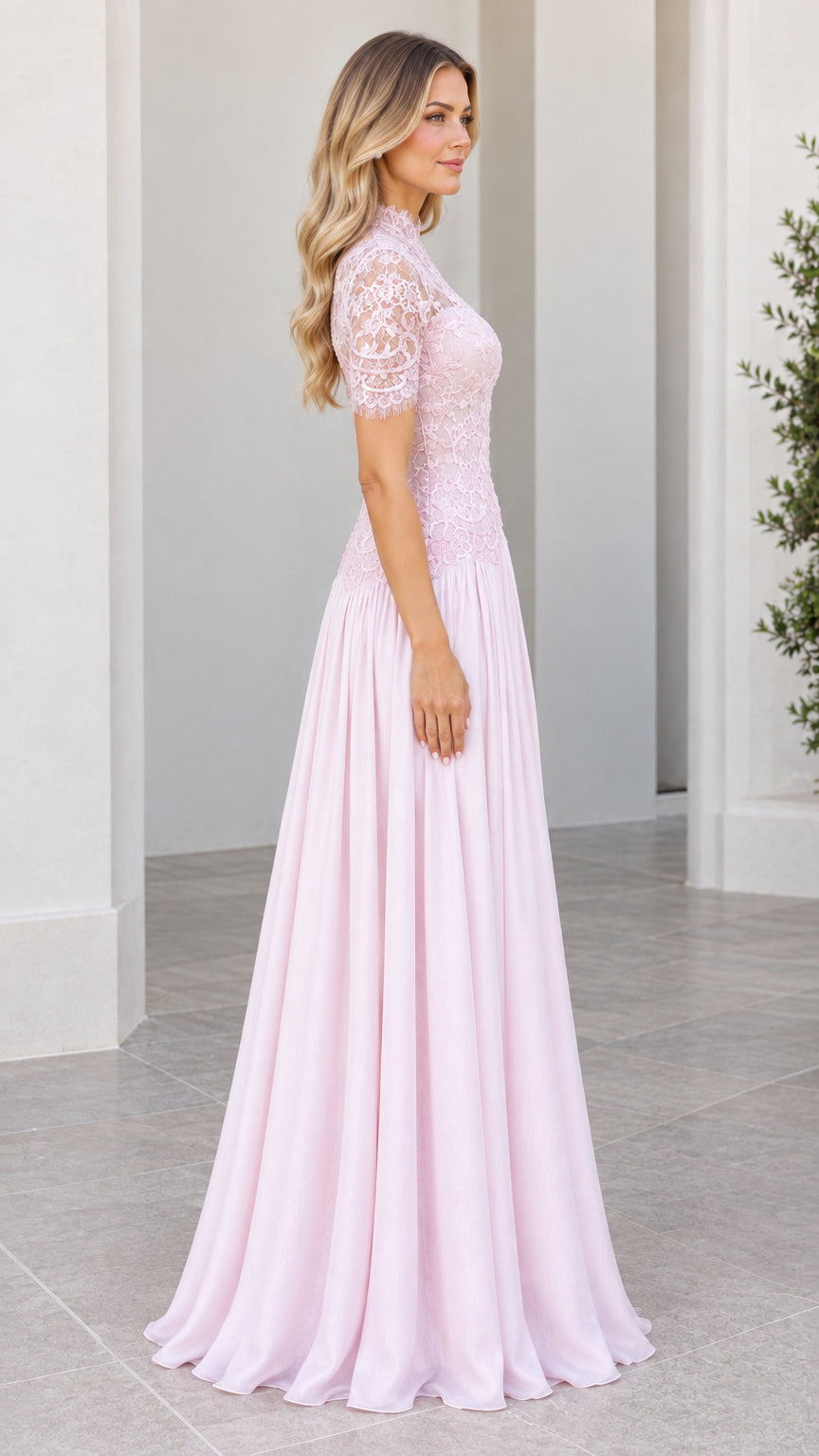 Side profile view of model in Blush Pink short sleeve lace and chiffon formal dress