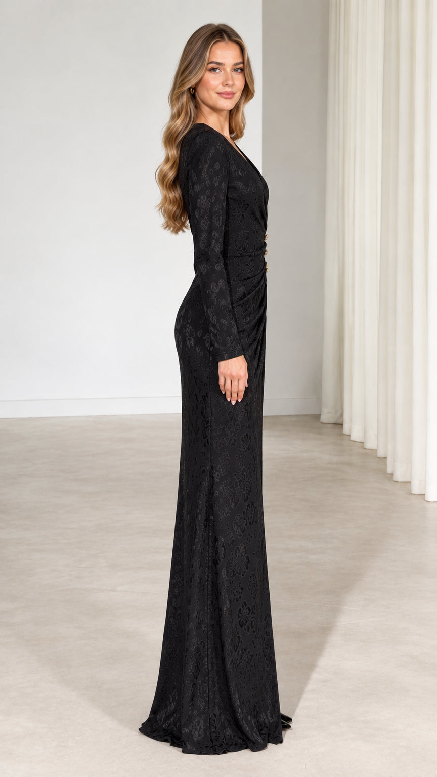 Side profile view of black long sleeve formal evening gown showing sleek silhouette
