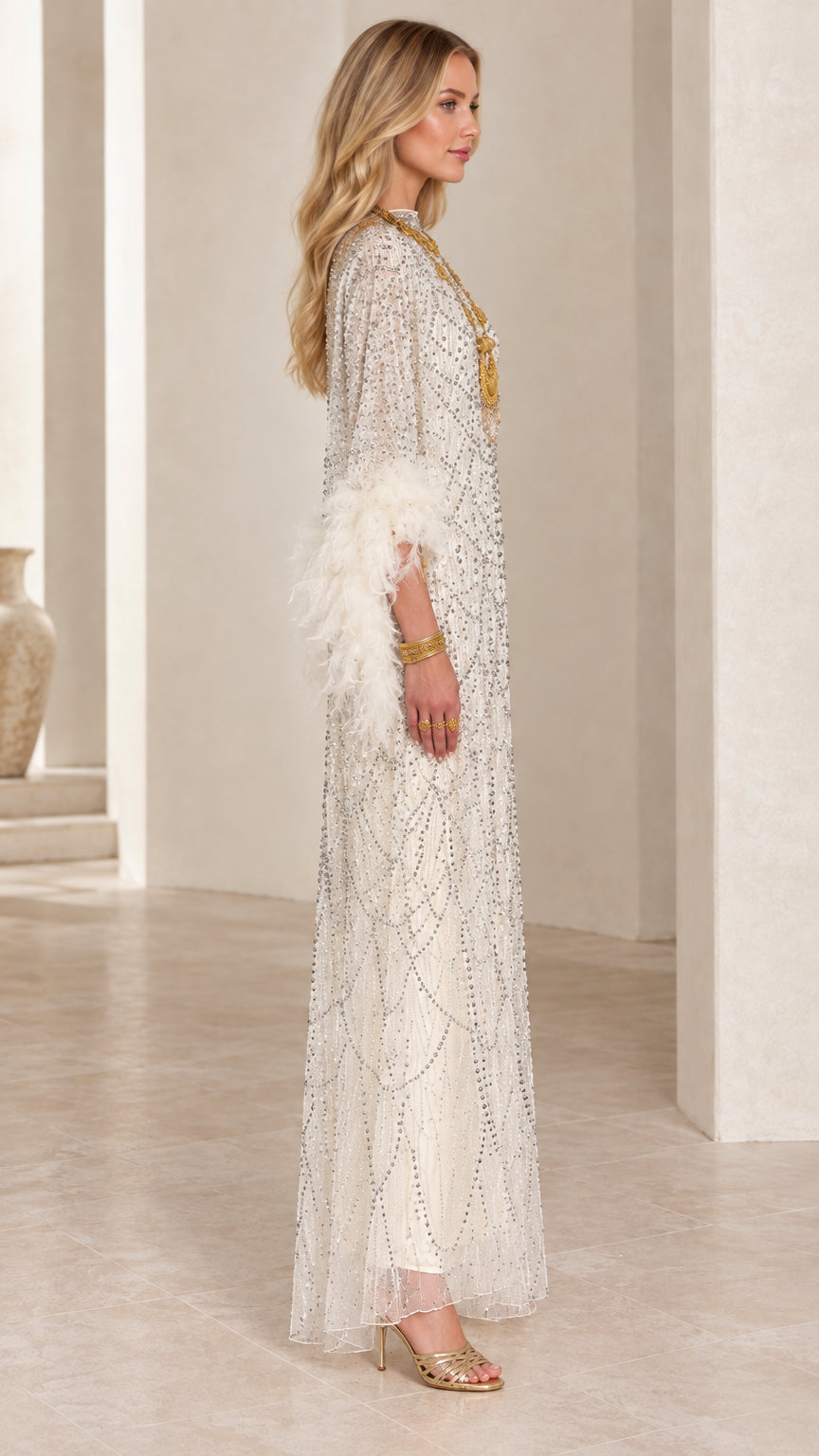 Side profile view of white beaded floor-length evening dress