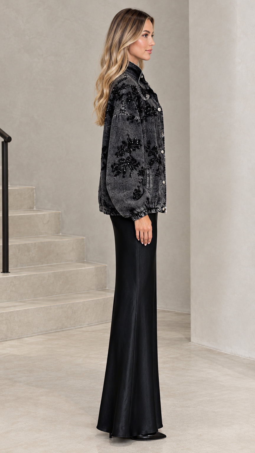 Side profile of washed black sequin denim jacket showing voluminous sleeves