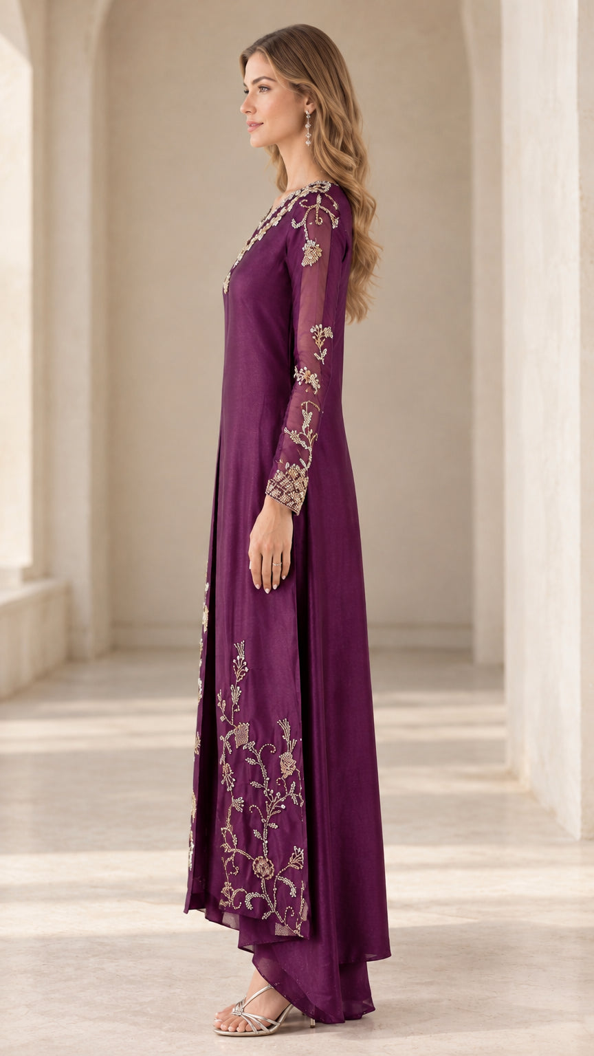 Side full-length view of woman in plum embroidered long tunic and pants set