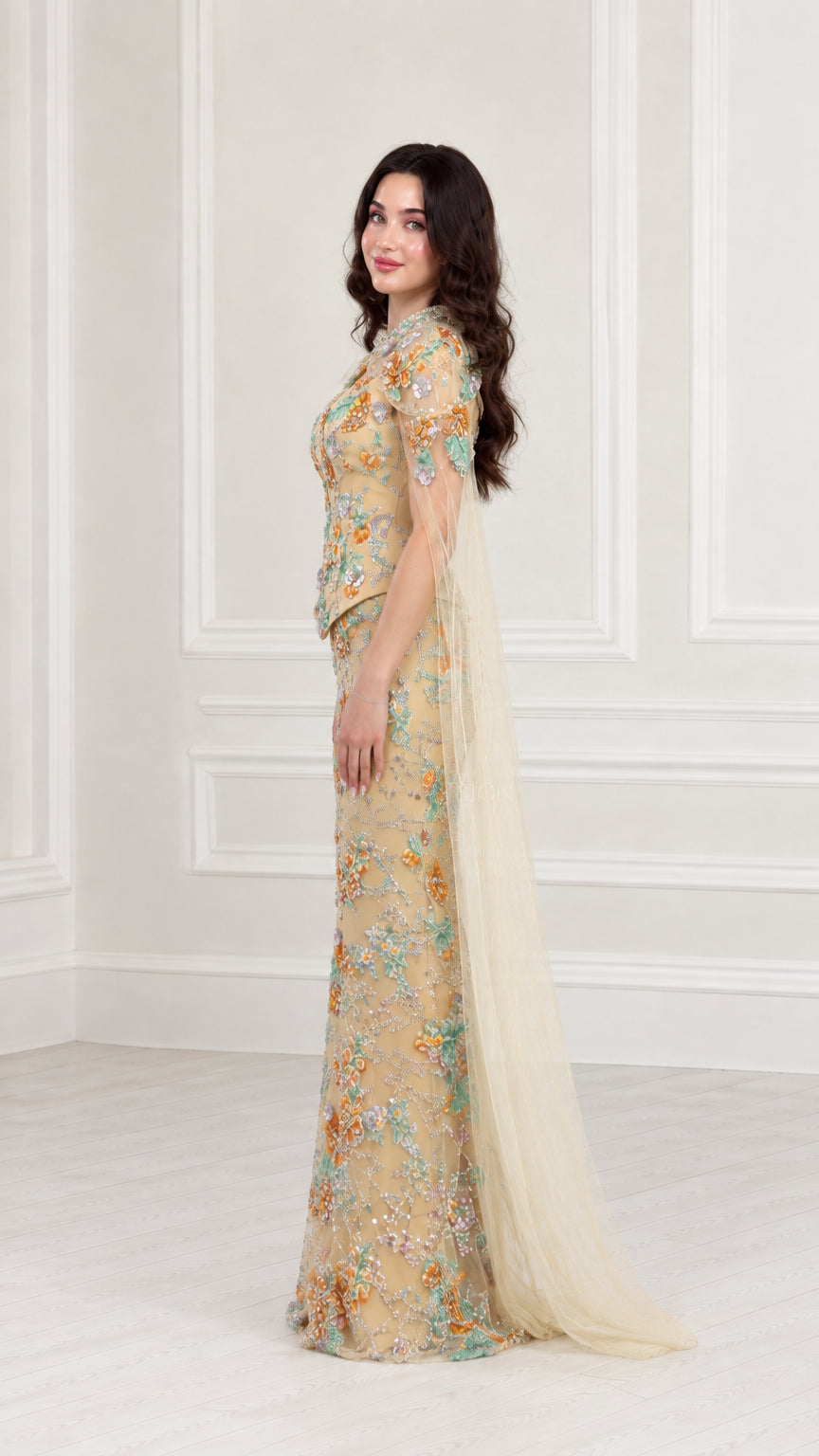 Side profile view of Champagne floral embroidered maxi dress with tulle cape detail