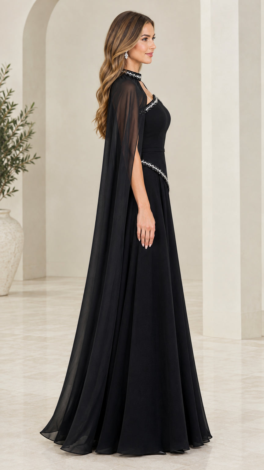 Side profile view of black evening gown showing dramatic sheer chiffon cape drape