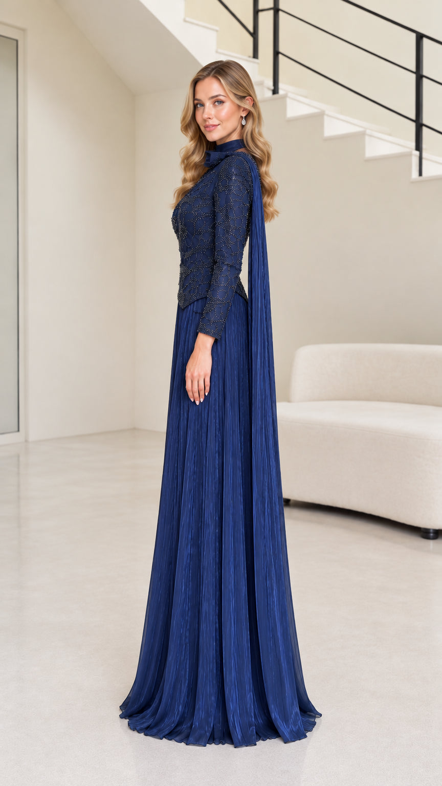 Side profile view of navy blue beaded mock neck formal dress with flowing shoulder sash