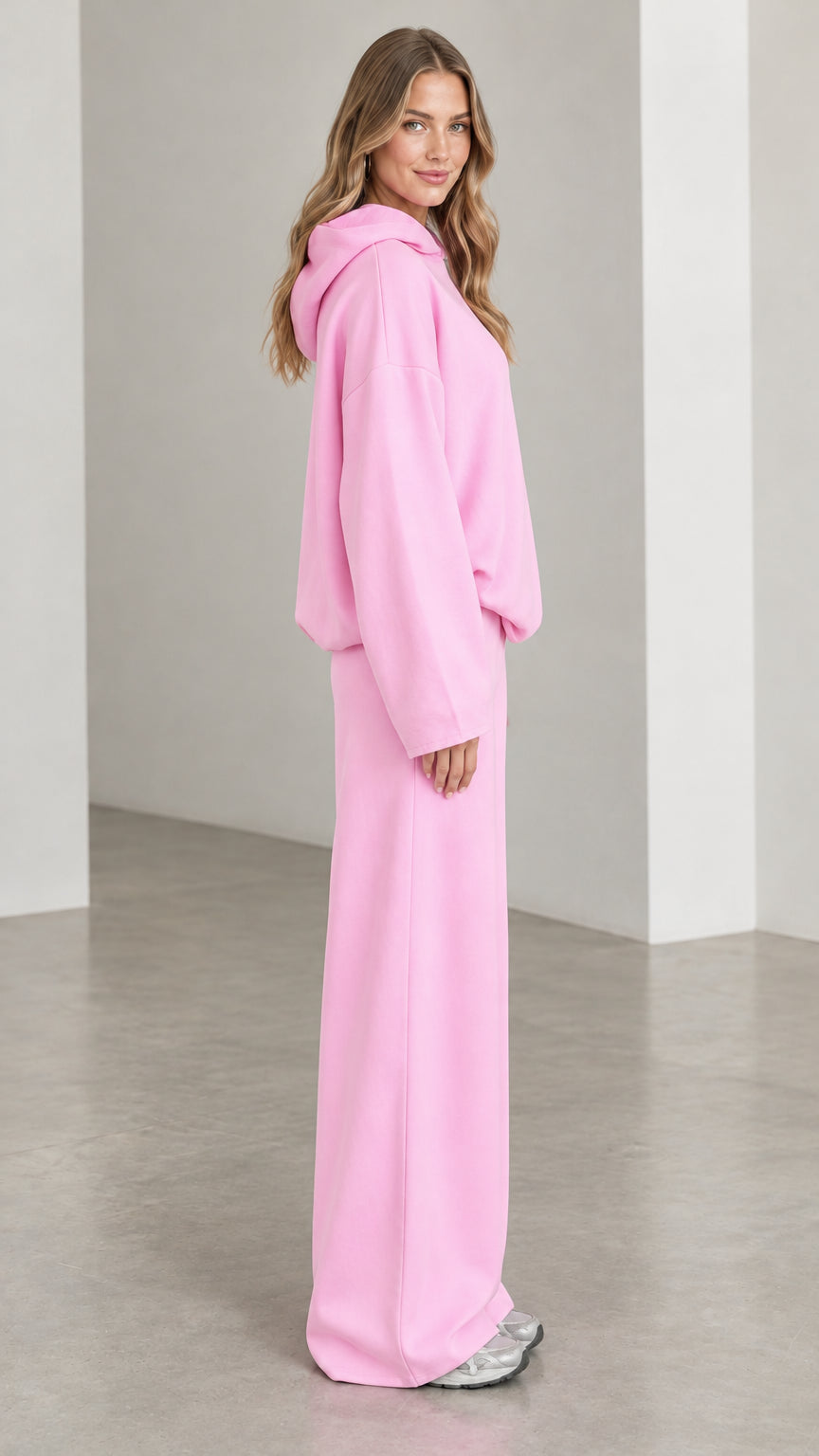Side profile view of woman wearing Light Pink matching hoodie and wide leg sweatpants