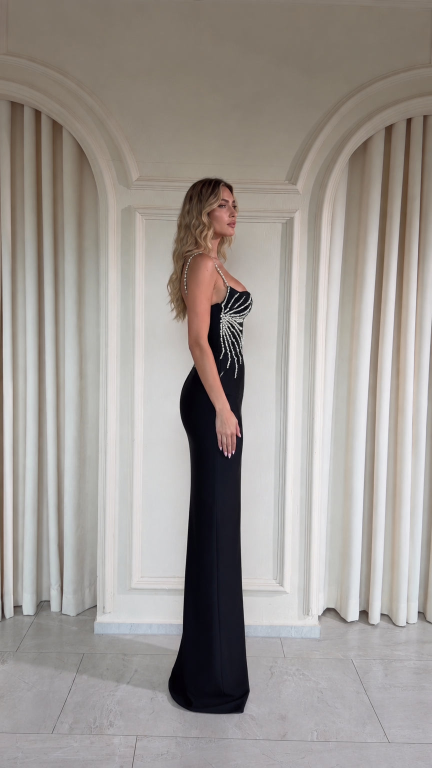Black embellished formal column gown side view showing sleek silhouette