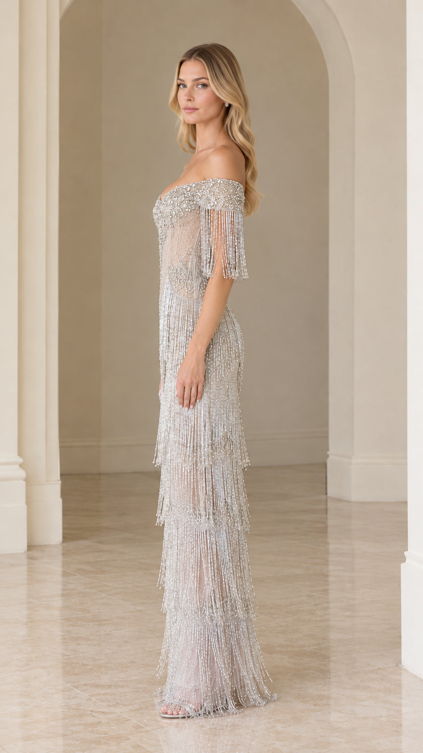 Side profile of woman in elegant silver tiered fringe formal dress