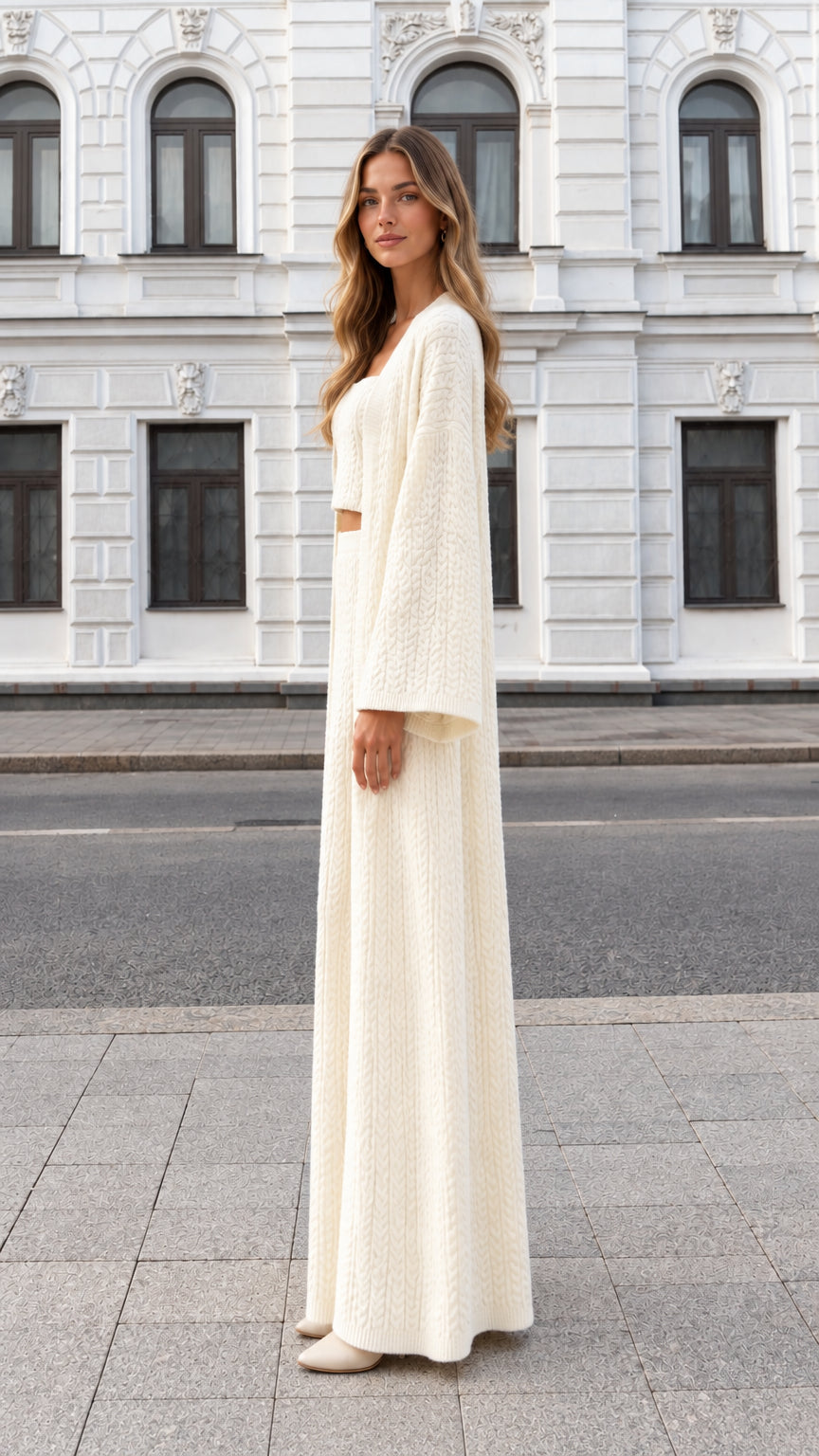 Side profile view of cream 3-piece cable knit outfit with long cardigan and matching maxi skirt