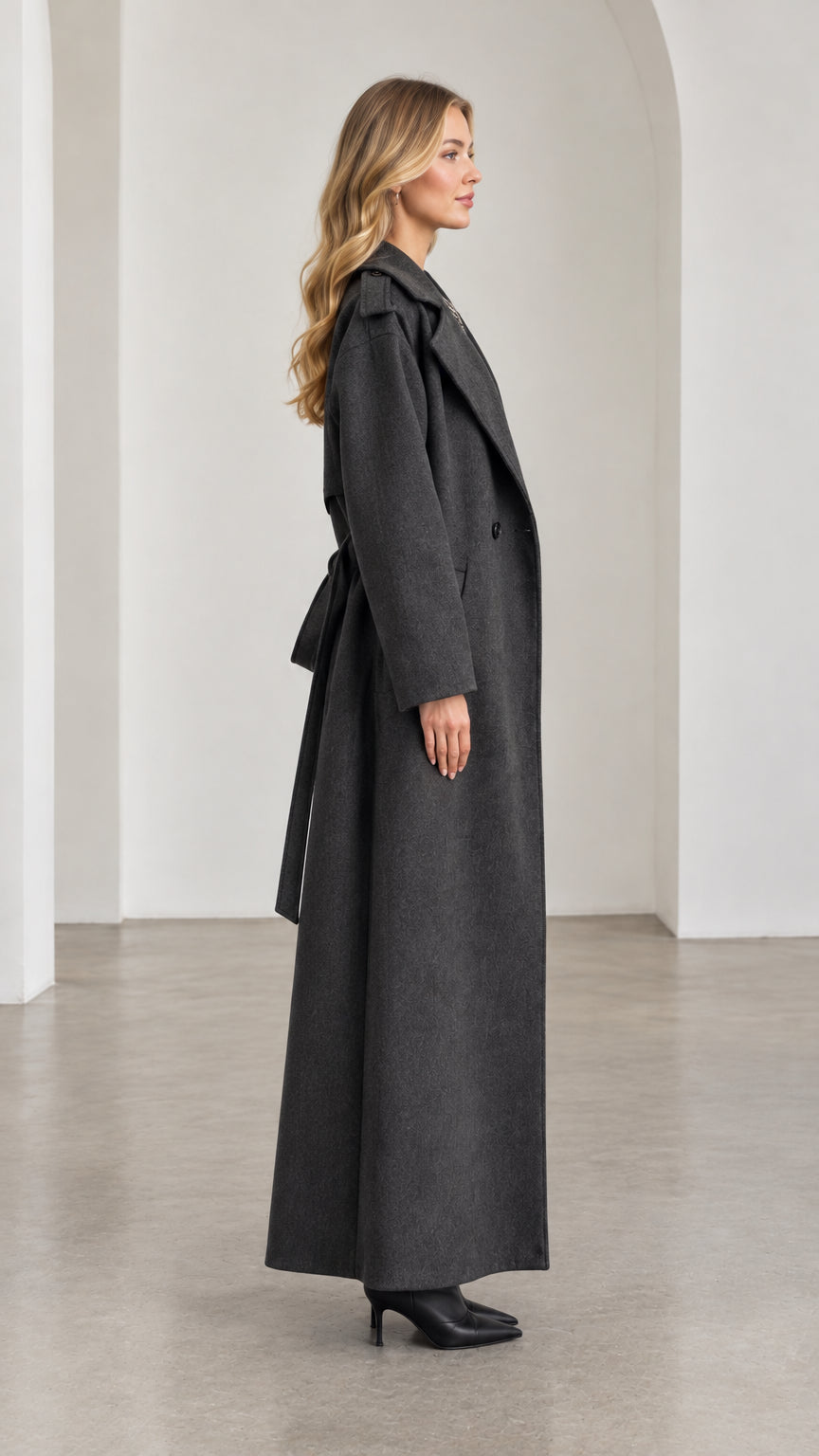 Side profile of model in full-length Charcoal Grey wool-look overcoat