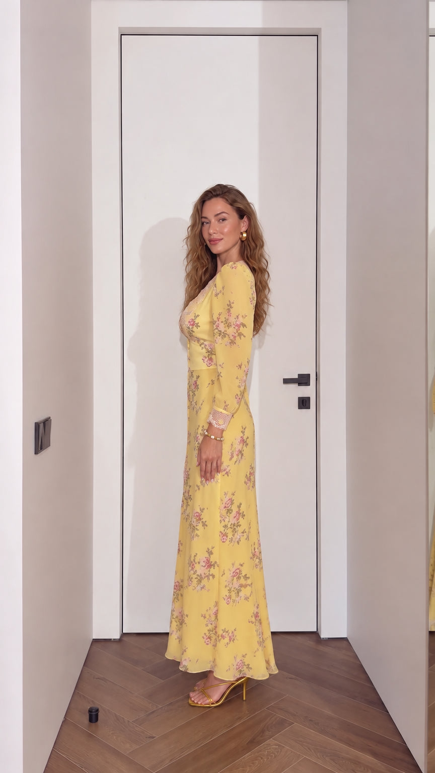 Side profile view of woman in yellow floral lace-trim maxi dress