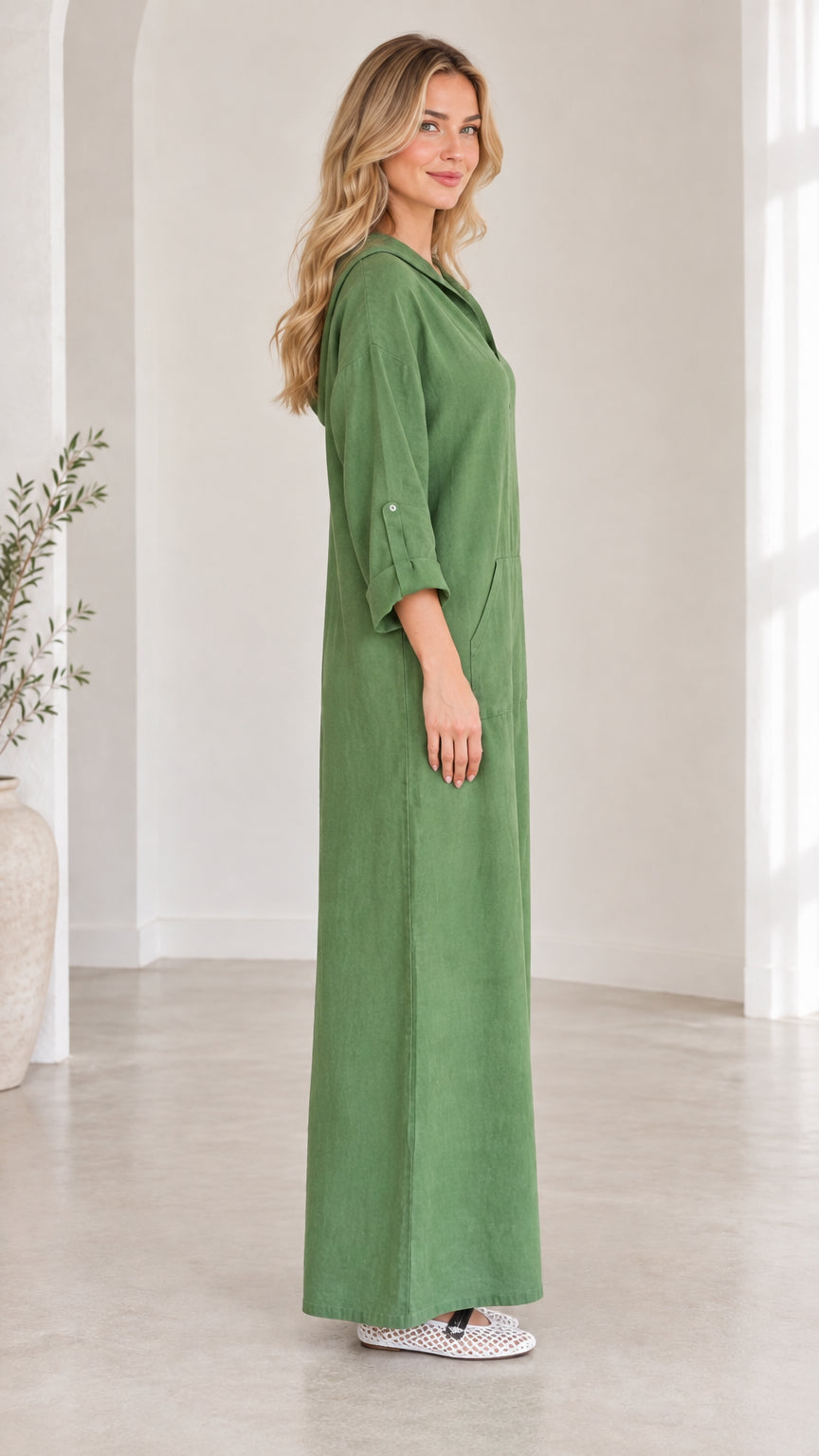 Side view of woman wearing green casual hooded maxi dress