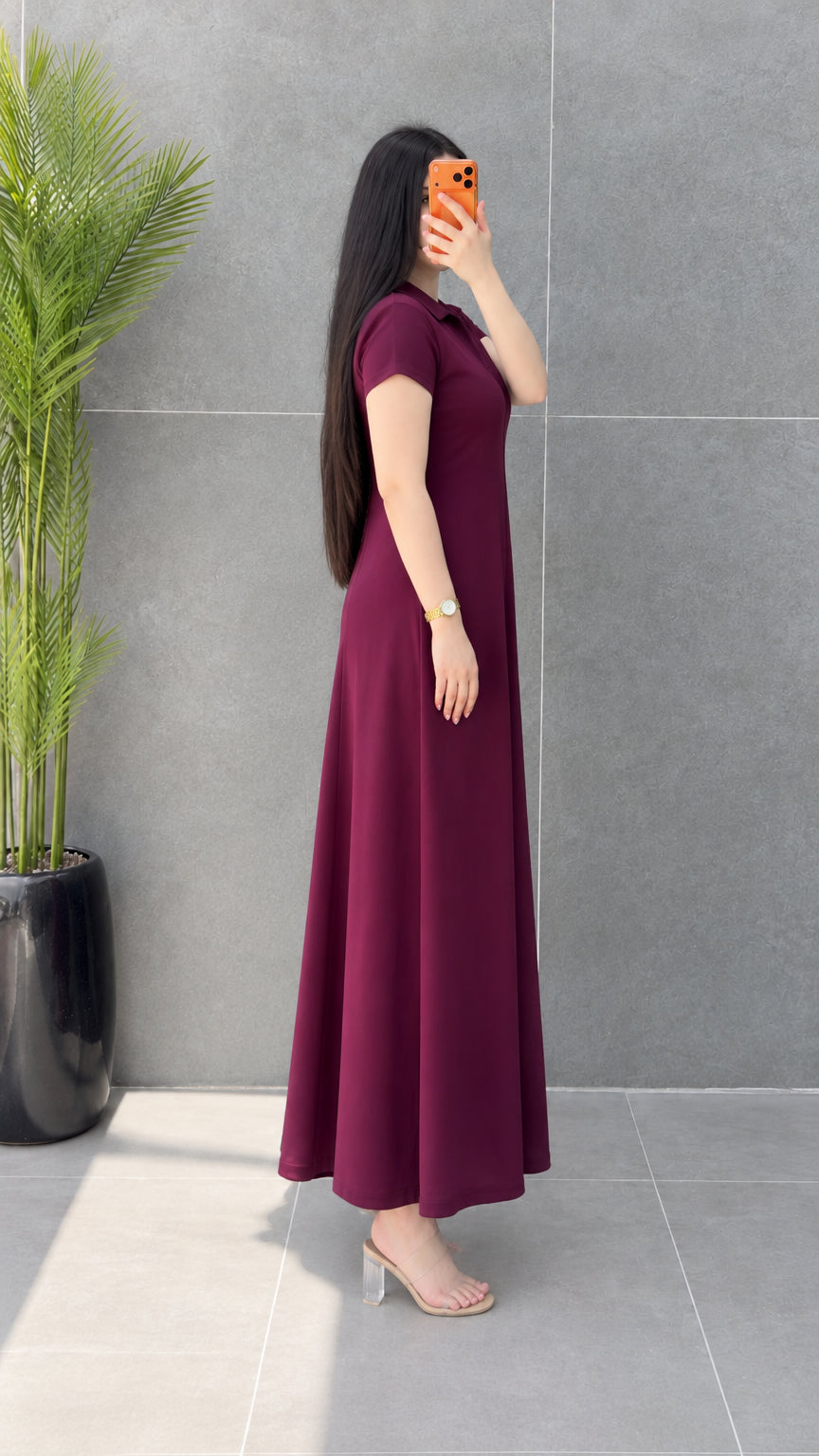 Side angle view of woman modeling flowy Burgundy short sleeve maxi dress