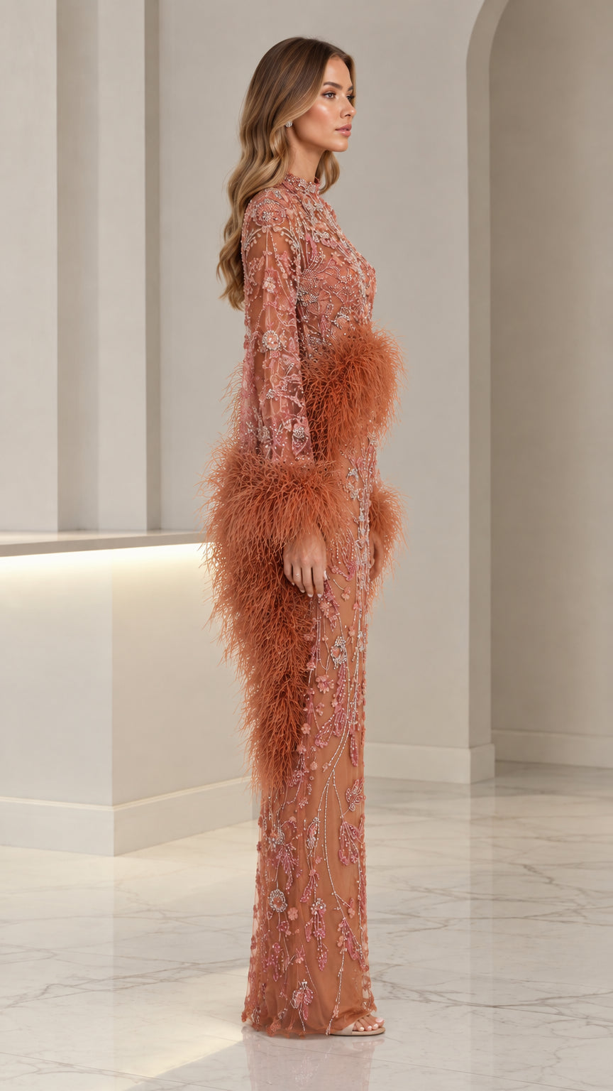 Side profile of woman in terracotta embellished column gown with feather trim waist detail