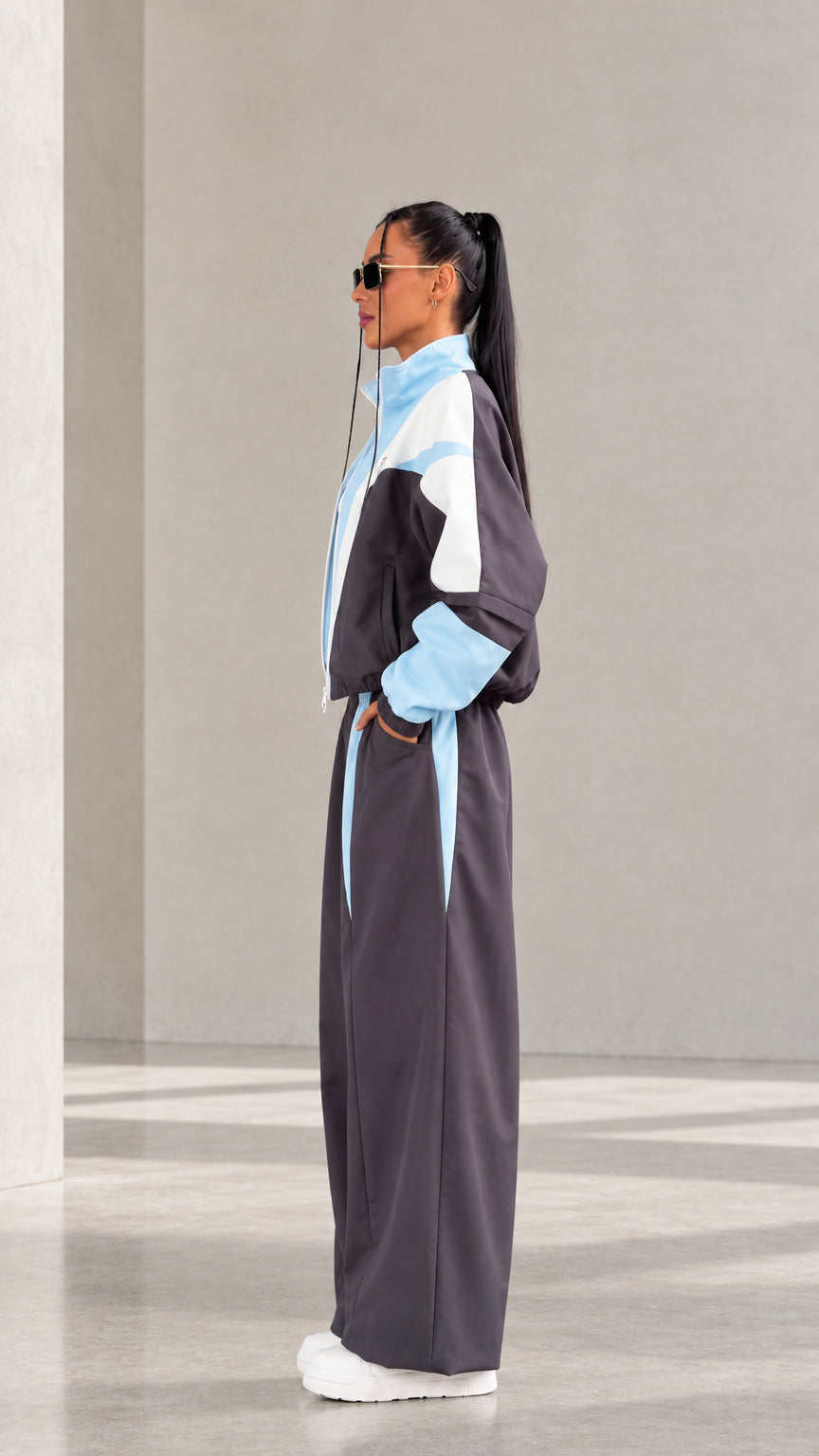 Model wearing Charcoal Grey colorblock tracksuit set side profile view