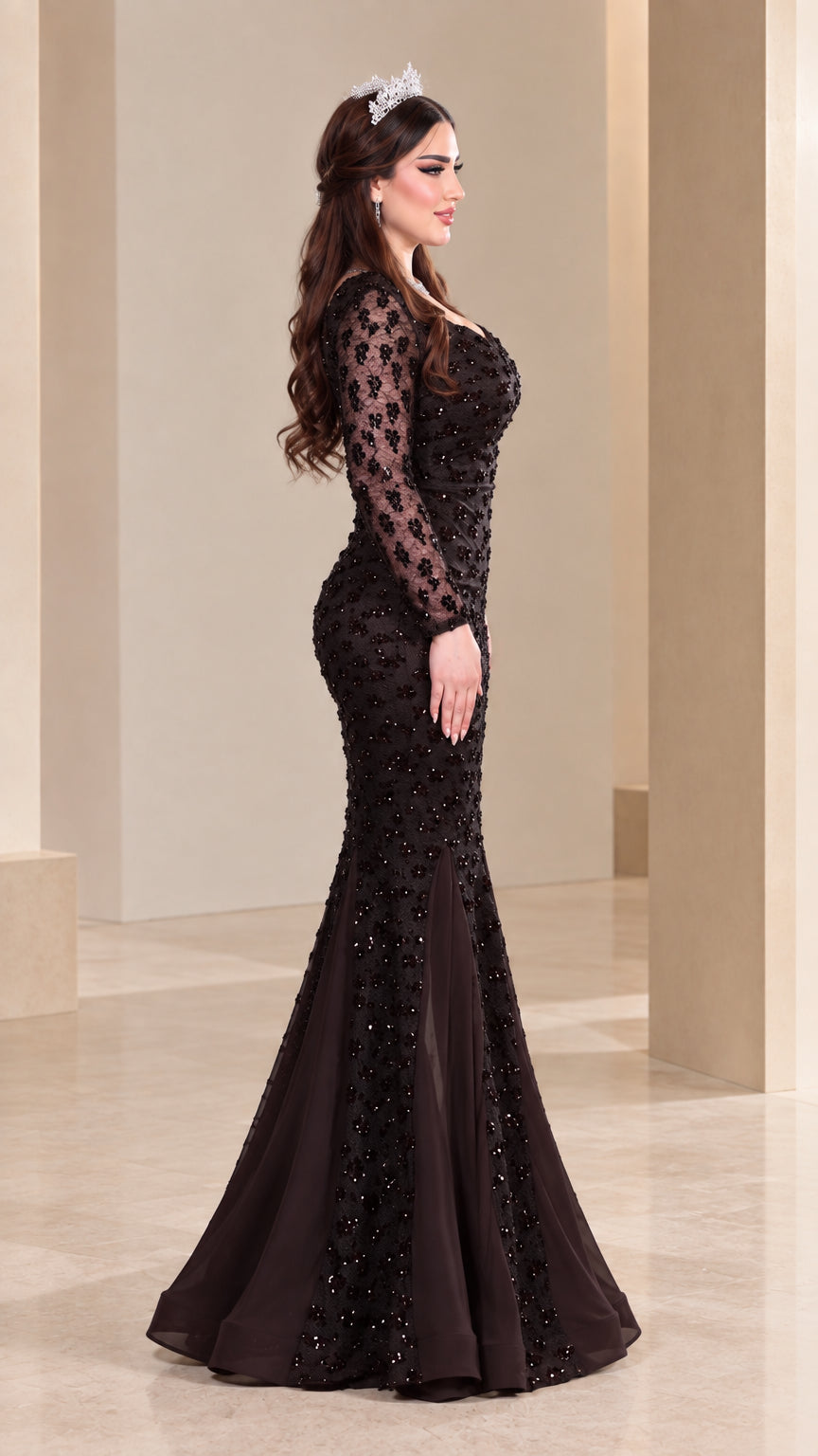 Side profile of model in dark brown sequin formal gown with flowing train
