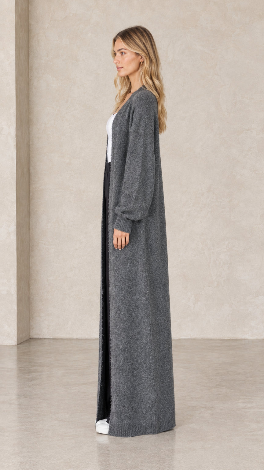 Side profile view of charcoal grey floor-length open front knit cardigan